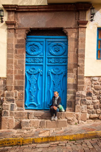 Alyssa Sitting by Blue Door in Cusco